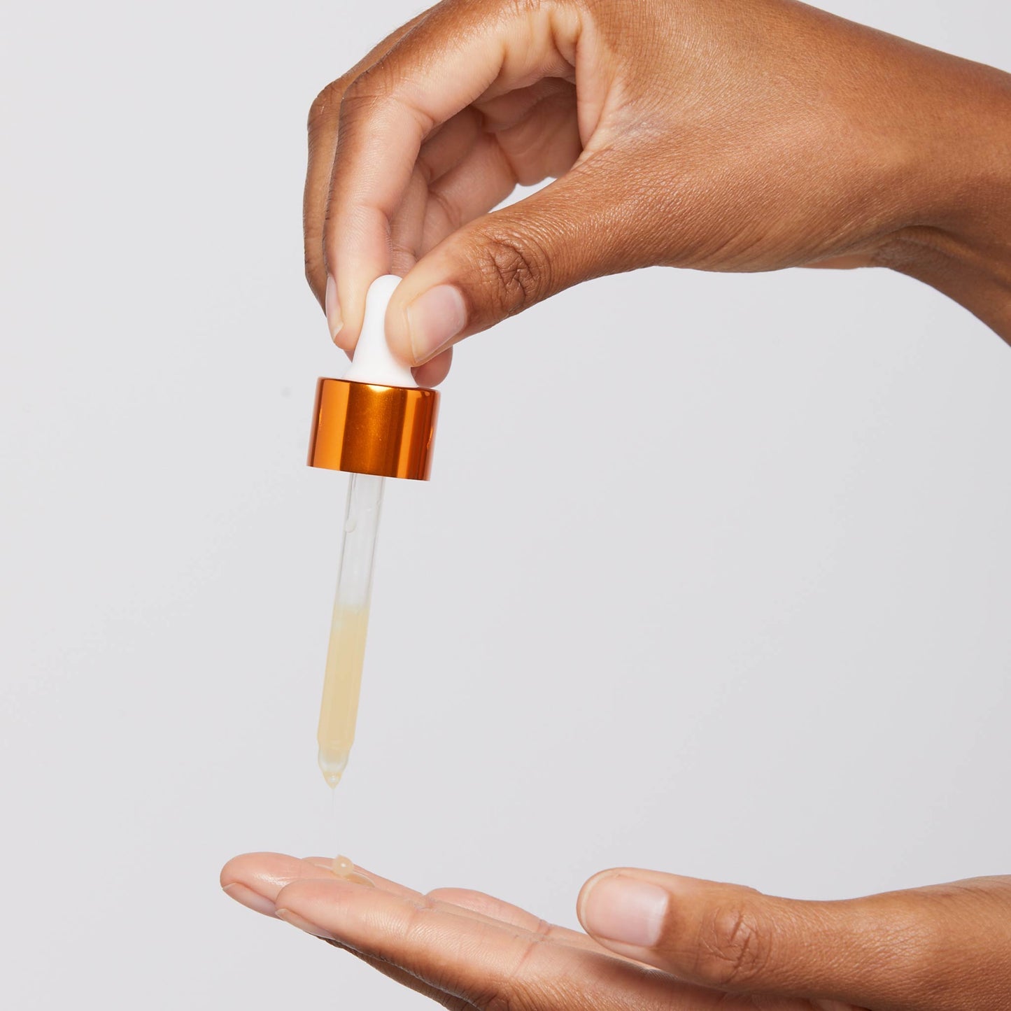 biolumin-c serum being dispensed onto fingertip