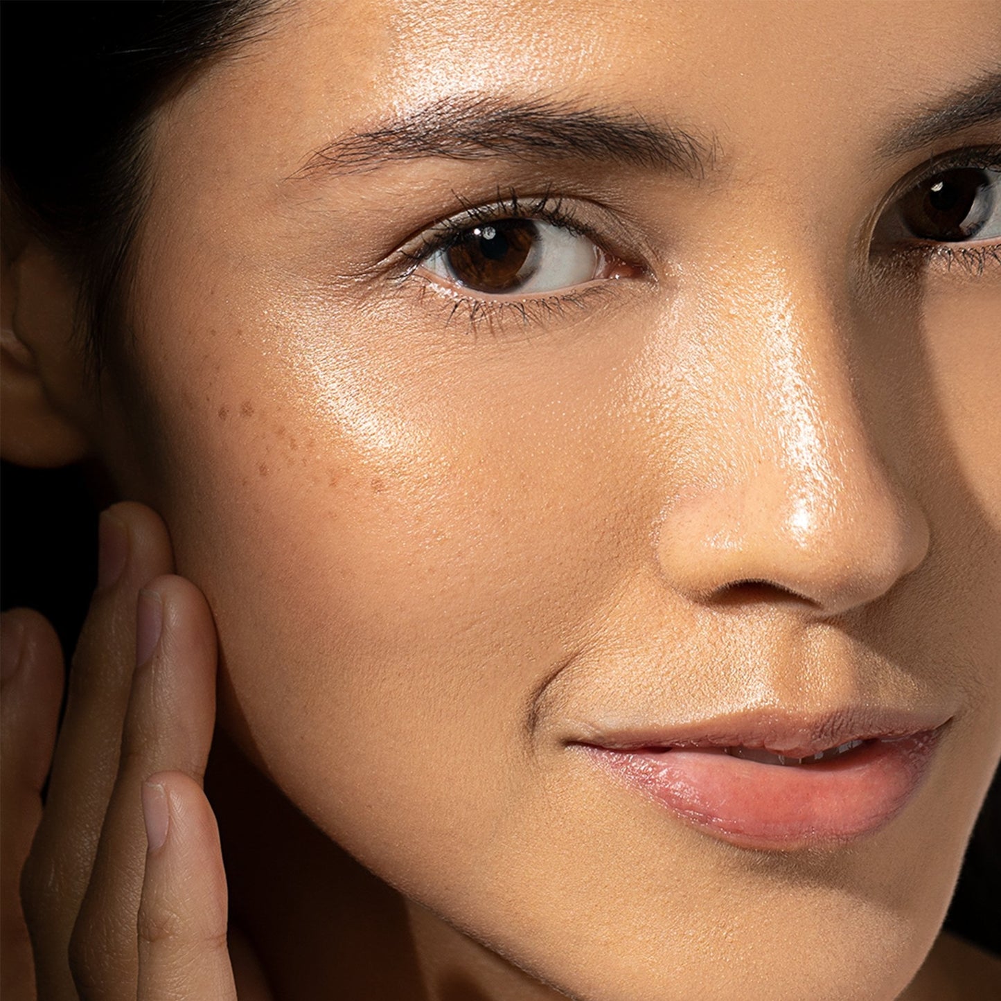 woman applying product to face
