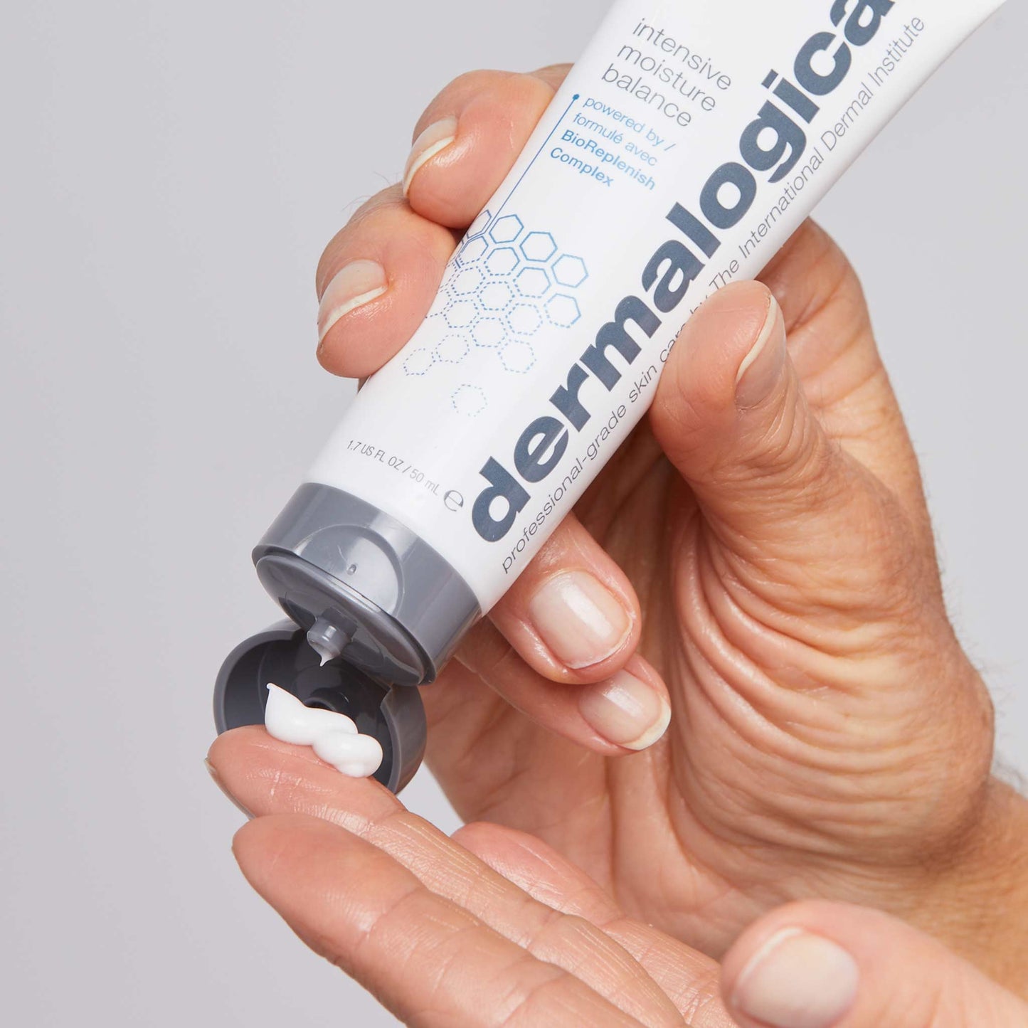 intensive moisture balance being dispensed onto fingertip