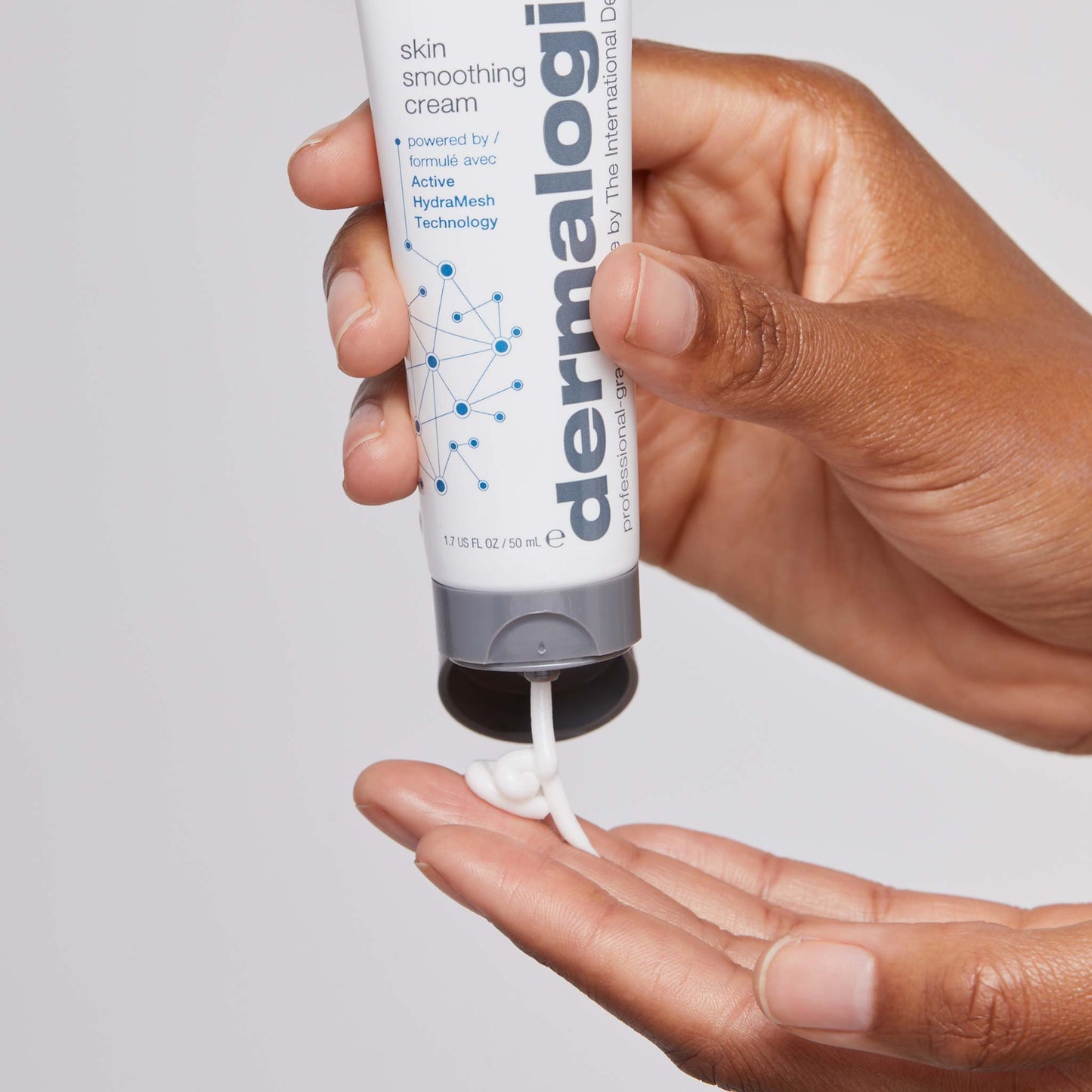 skin smoothing cream being dispensed onto fingertip