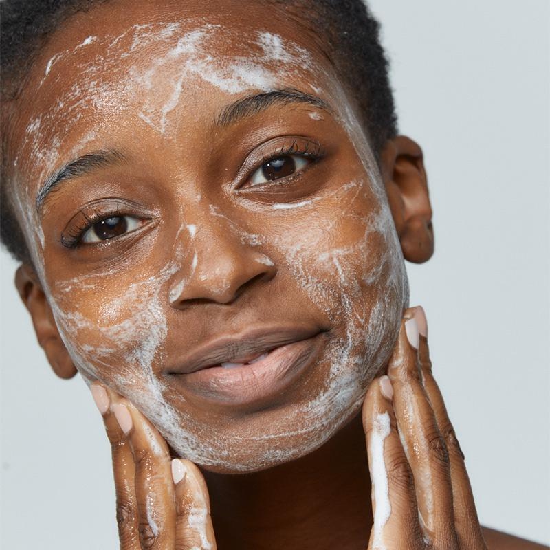 woman cleansing face with special cleansing gel
